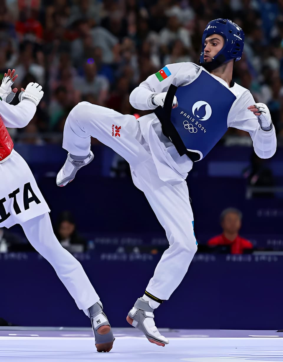 Two taekwondo students sparring in a tournament