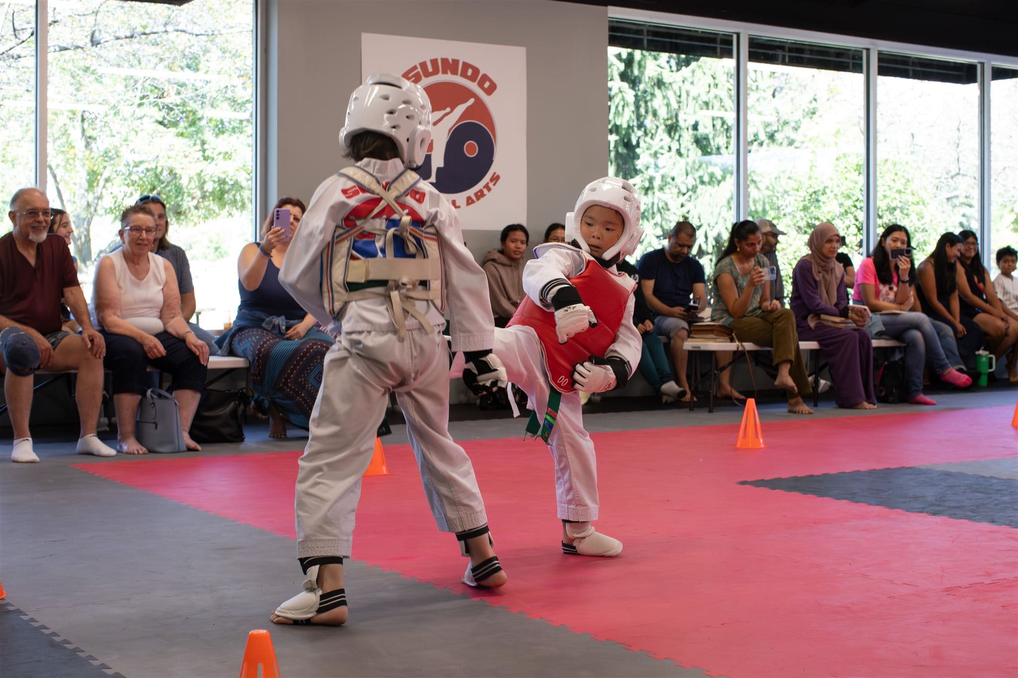 Two young taekwondo students sparring.