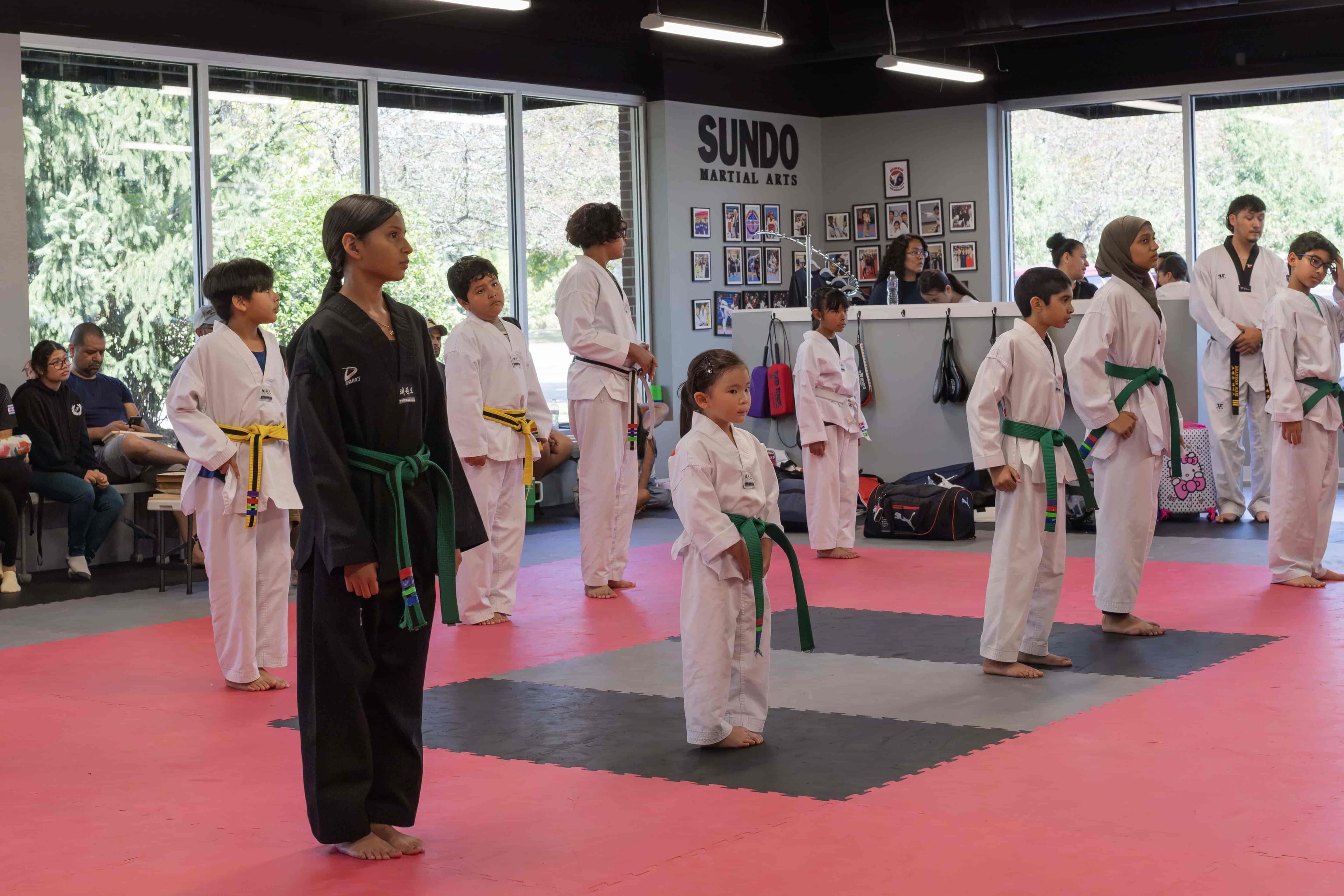 Young Sundo students standing at attention for testing